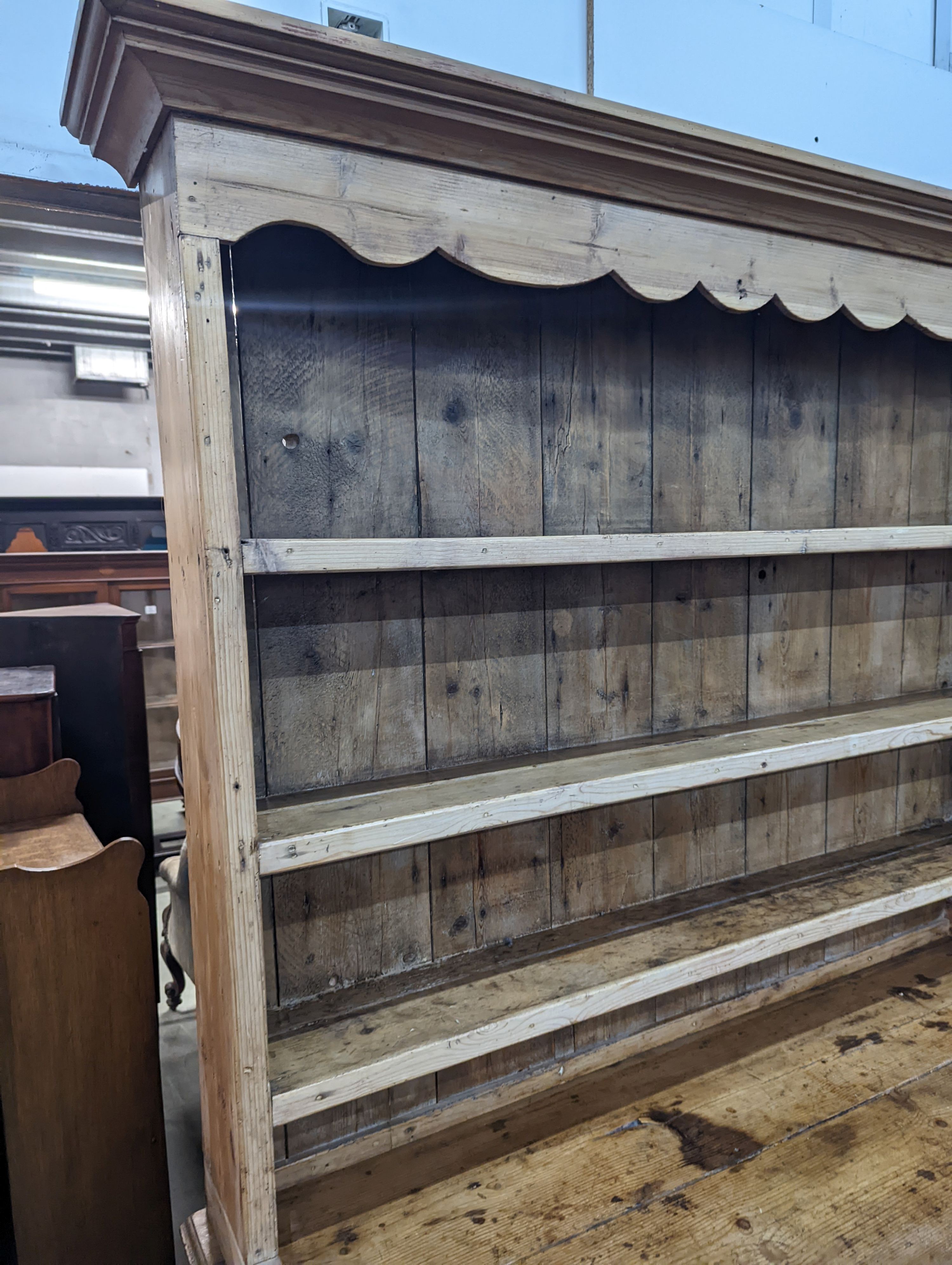 An early 19th century pine dresser with boarded rack, width 141cm, depth 49cm, height 206cm